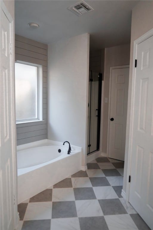 bathroom featuring separate shower and tub