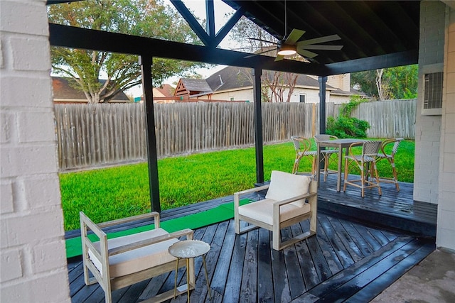 deck with a lawn and ceiling fan