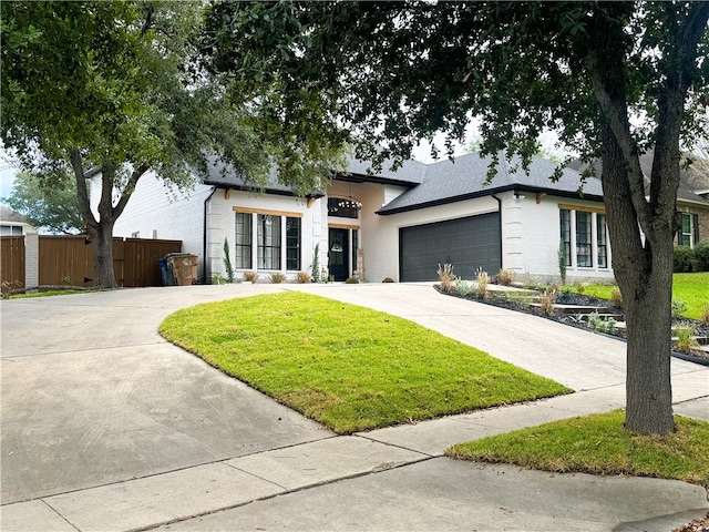 single story home featuring a front yard and a garage