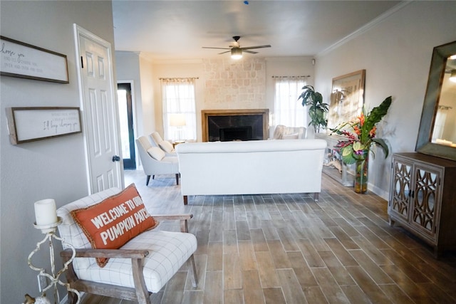 living room with ceiling fan, crown molding, a healthy amount of sunlight, and dark hardwood / wood-style floors