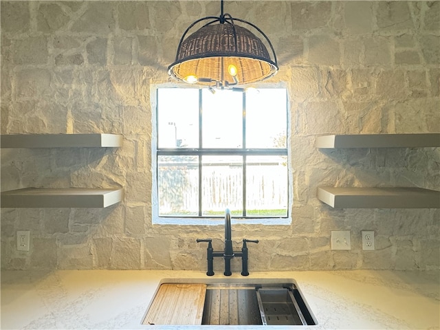 kitchen featuring hanging light fixtures, a healthy amount of sunlight, and sink