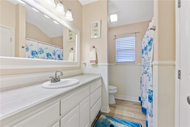 13805 Hawksnest Bay Dr, Corpus Christi, TX 78418 - full bath with vanity, a wainscoted wall, wood finished floors, and a shower with shower curtain
