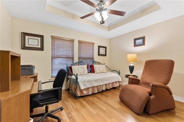 13805 Hawksnest Bay Dr, Corpus Christi, TX 78418 - bedroom featuring a raised ceiling, light wood-style flooring, crown molding, an office area, and a ceiling fan