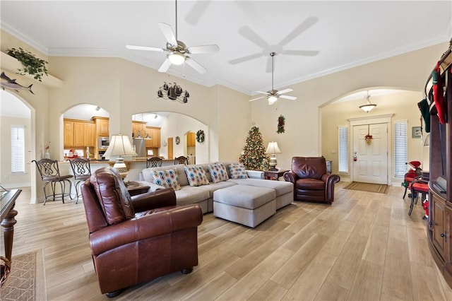 13805 Hawksnest Bay Dr, Corpus Christi, TX 78418 - living room featuring arched walkways, light wood-type flooring, ornamental molding, and a ceiling fan