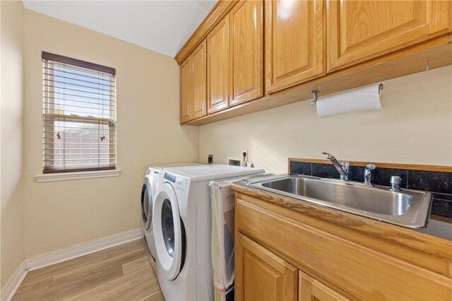 13805 Hawksnest Bay Dr, Corpus Christi, TX 78418 - laundry room featuring cabinet space, independent washer and dryer, and light wood-style flooring