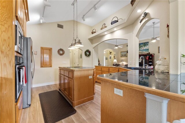 13805 Hawksnest Bay Dr, Corpus Christi, TX 78418 - kitchen with ceiling fan, track lighting, arched walkways, appliances with stainless steel finishes, and high vaulted ceiling