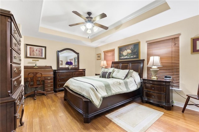 13805 Hawksnest Bay Dr, Corpus Christi, TX 78418 - bedroom featuring a raised ceiling, light wood-style flooring, ornamental molding, and a ceiling fan