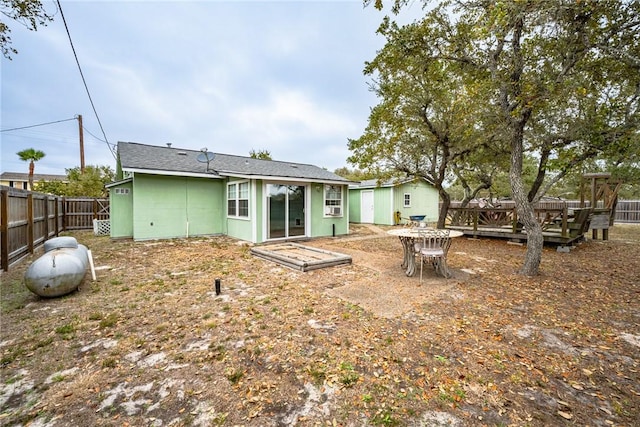 back of property with a wooden deck