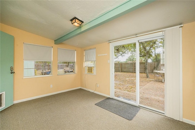 interior space featuring cooling unit, carpet floors, and lofted ceiling with beams