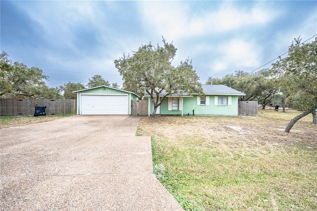 ranch-style home featuring a garage and a front lawn