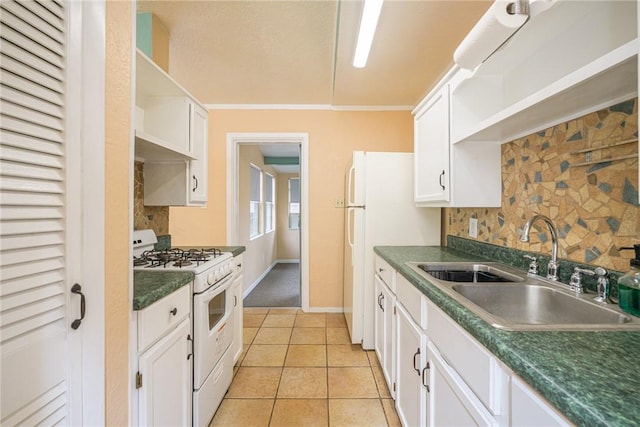 kitchen featuring white range with gas cooktop, sink, white cabinetry, and light tile patterned flooring