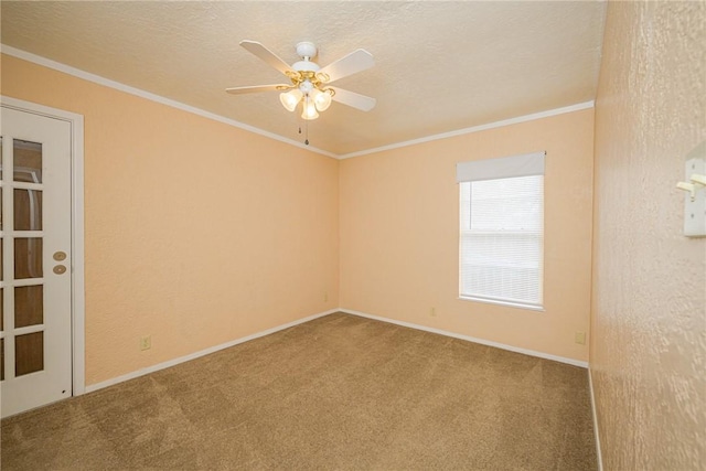 unfurnished room featuring ceiling fan, ornamental molding, carpet floors, and a textured ceiling