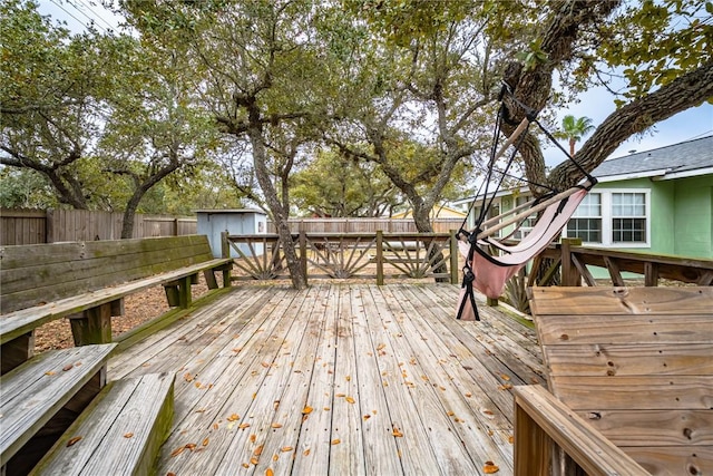 wooden terrace featuring a storage unit