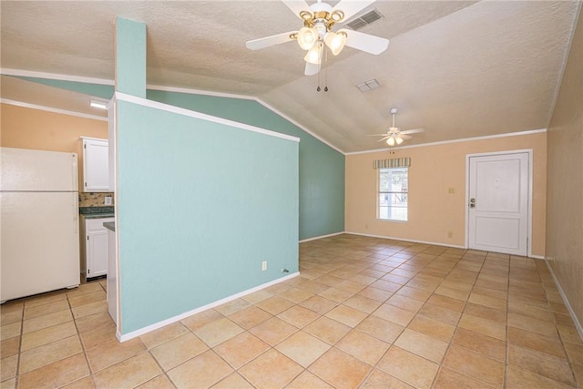 unfurnished living room with vaulted ceiling, ornamental molding, light tile patterned floors, ceiling fan, and a textured ceiling