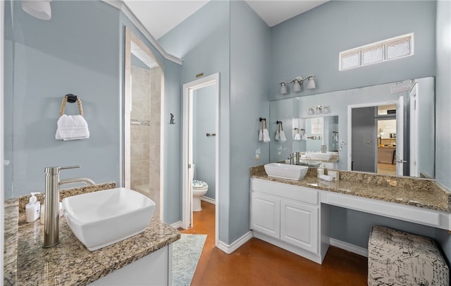 2212 State Highway 361, Port Aransas, TX 78373 - bathroom featuring vanity, finished concrete flooring, a high ceiling, and a tile shower