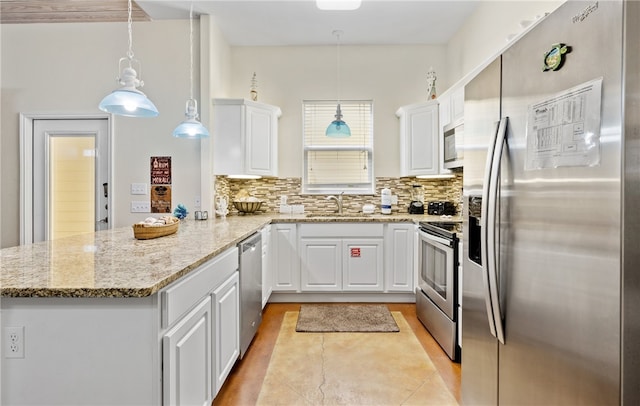 2212 State Highway 361, Port Aransas, TX 78373 - kitchen with stainless steel appliances, a peninsula, white cabinetry, and tasteful backsplash