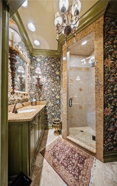 bathroom with vanity, ornamental molding, a notable chandelier, and a shower stall