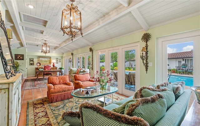 sunroom / solarium with a notable chandelier and beam ceiling