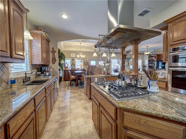 13834 Captains Row, Corpus Christi, TX 78418 - kitchen with appliances with stainless steel finishes, island exhaust hood, arched walkways, light stone counters, and recessed lighting