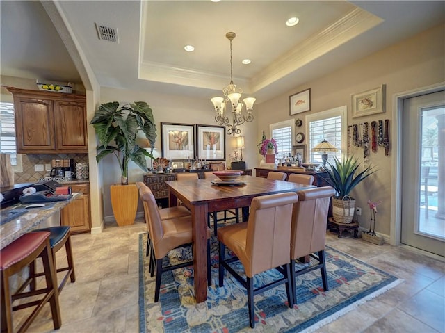 13834 Captains Row, Corpus Christi, TX 78418 - dining space with a chandelier, a tray ceiling, ornamental molding, and recessed lighting