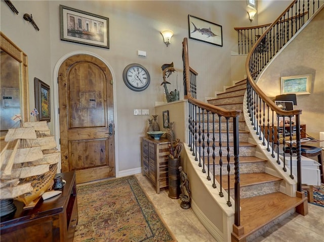 13834 Captains Row, Corpus Christi, TX 78418 - foyer entrance featuring a high ceiling, stairs, and arched walkways