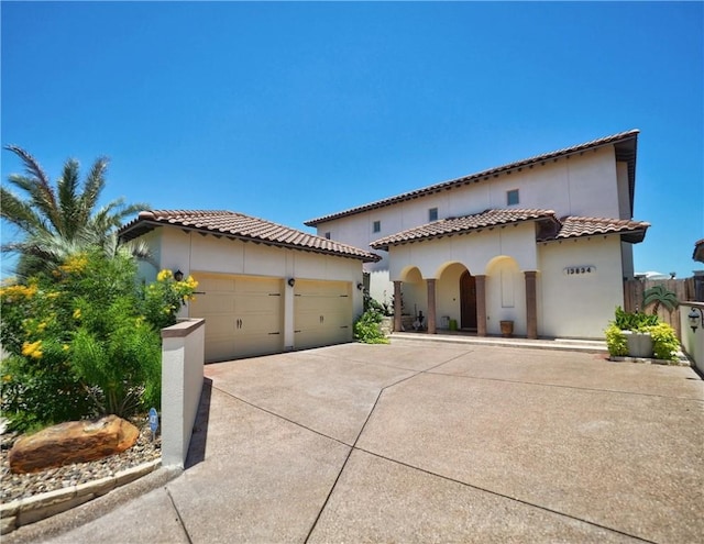 13834 Captains Row, Corpus Christi, TX 78418 - mediterranean / spanish home featuring an attached garage, stucco siding, driveway, and a tile roof