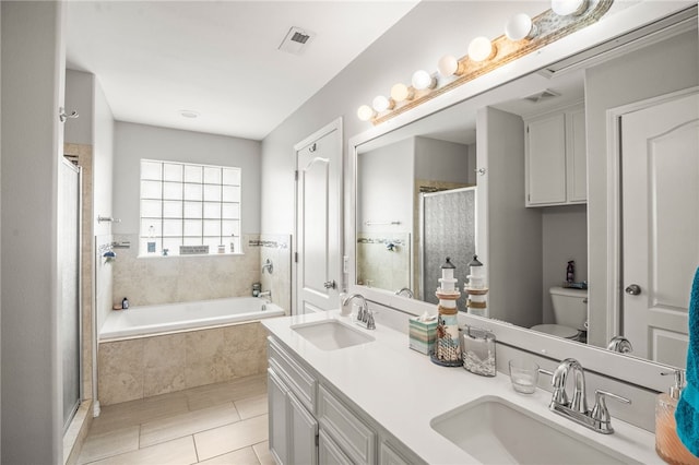 full bathroom featuring toilet, shower with separate bathtub, tile patterned floors, and vanity