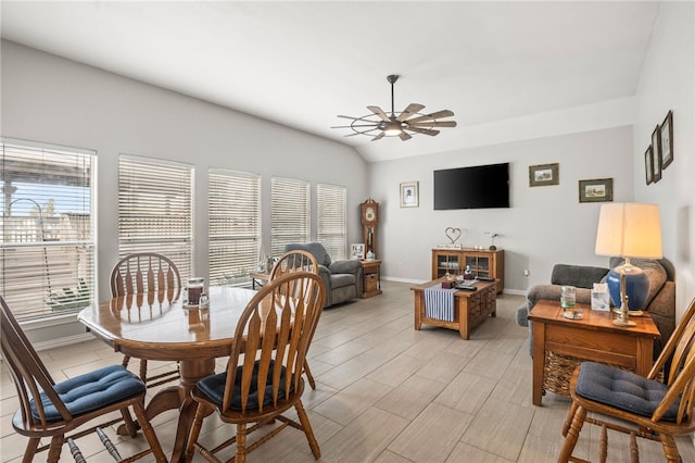 dining area featuring ceiling fan and lofted ceiling