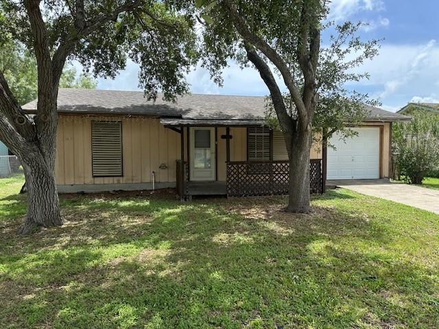 10949 Gates Ln, Corpus Christi, TX 78410 - view of front of home featuring driveway, a garage, and a front yard