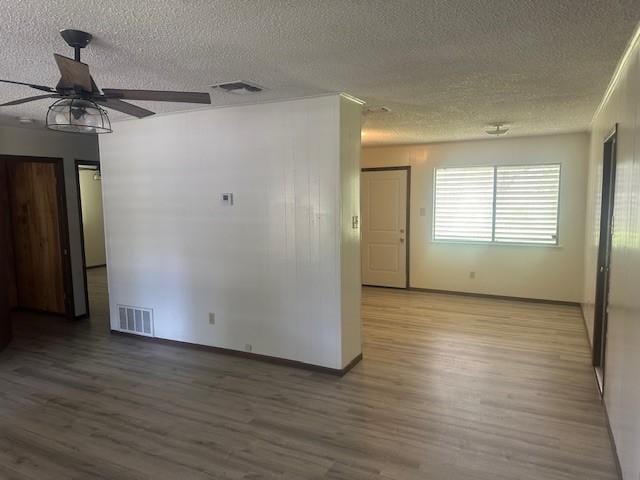 10949 Gates Ln, Corpus Christi, TX 78410 - spare room with a textured ceiling, wood finished floors, and a ceiling fan