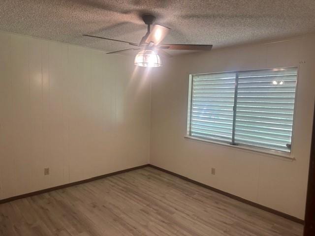 10949 Gates Ln, Corpus Christi, TX 78410 - spare room with a ceiling fan, wood finished floors, and a textured ceiling