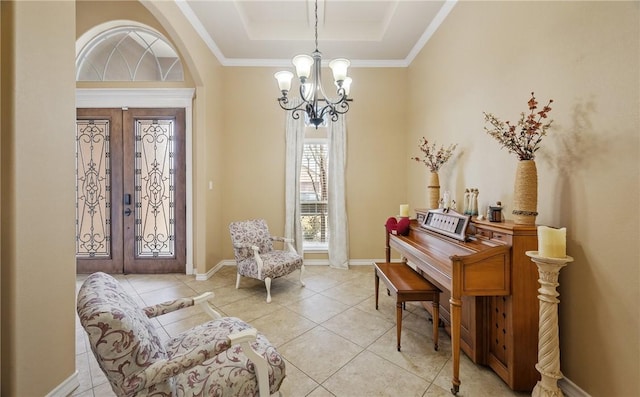 living area with a notable chandelier, a tray ceiling, light tile patterned floors, and french doors