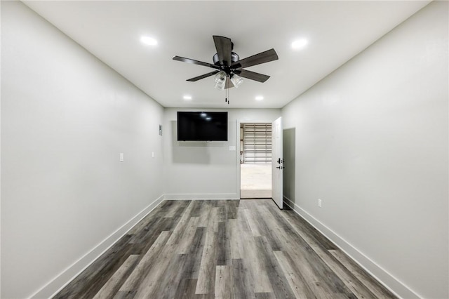 empty room with baseboards, recessed lighting, ceiling fan, and dark wood-style floors