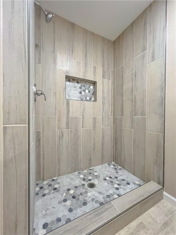 bathroom with a tile shower