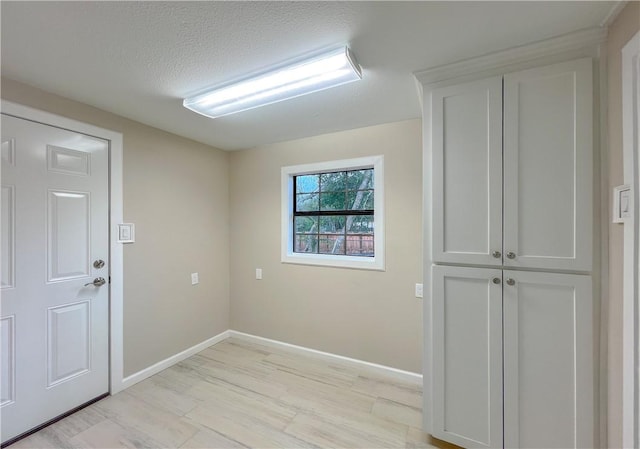 unfurnished room with a textured ceiling