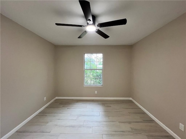 spare room with ceiling fan and light wood-type flooring