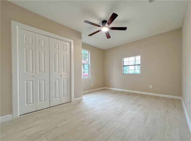 unfurnished bedroom with ceiling fan, light hardwood / wood-style floors, and a closet