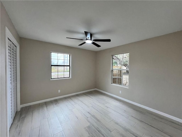 unfurnished bedroom with ceiling fan and light hardwood / wood-style flooring