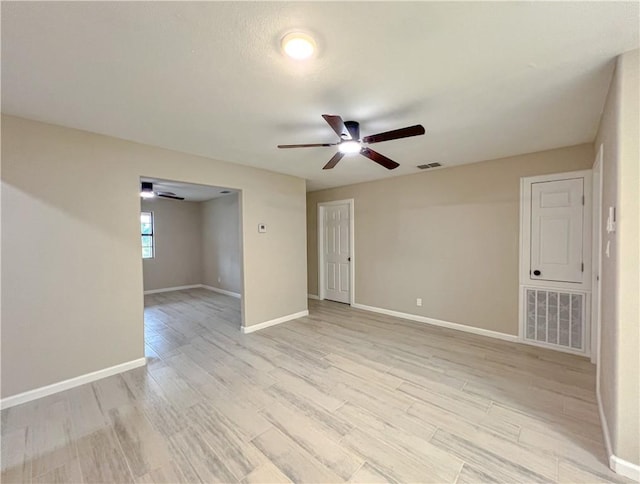 spare room with ceiling fan and light hardwood / wood-style floors