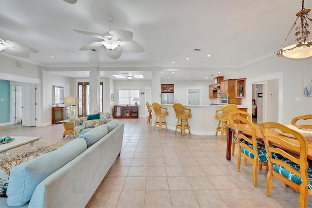 living room featuring ceiling fan, ornamental molding, and light tile patterned floors