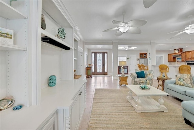 living room featuring crown molding and light tile patterned floors