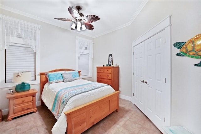 tiled bedroom featuring a closet, ceiling fan, and ornamental molding