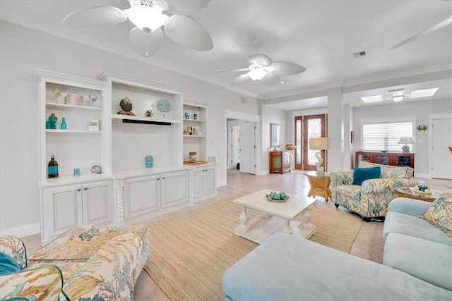 tiled living room featuring ceiling fan and crown molding