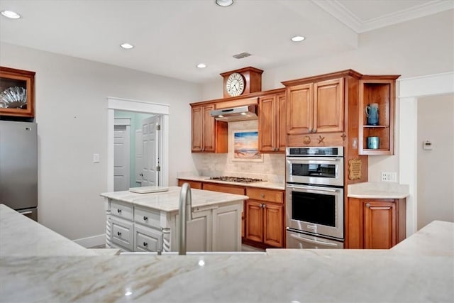 kitchen featuring stainless steel appliances, a center island, crown molding, sink, and backsplash