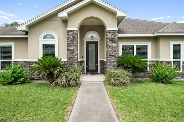 116 James Dr, Sinton, TX 78387 - entrance to property featuring stone siding, stucco siding, and a lawn