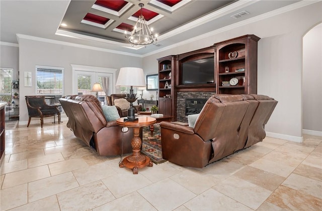 116 James Dr, Sinton, TX 78387 - living area featuring crown molding, a chandelier, baseboards, a stone fireplace, and arched walkways