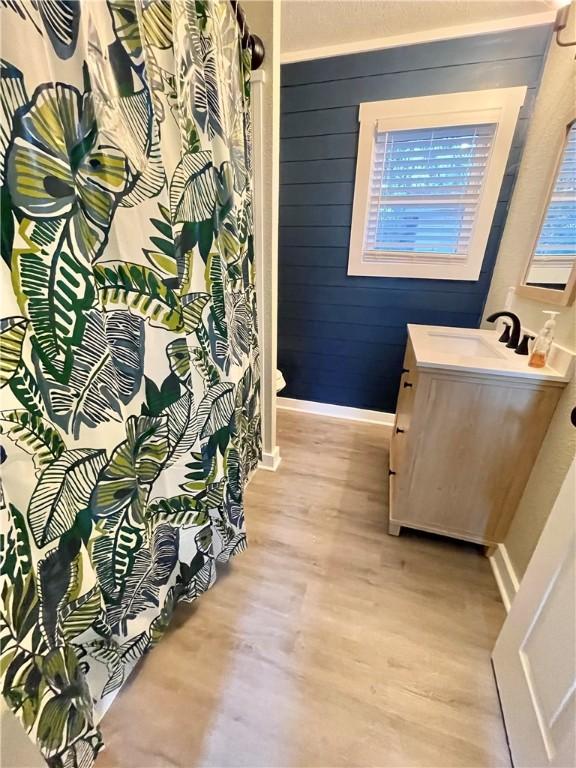 interior space featuring hardwood / wood-style floors, vanity, and toilet