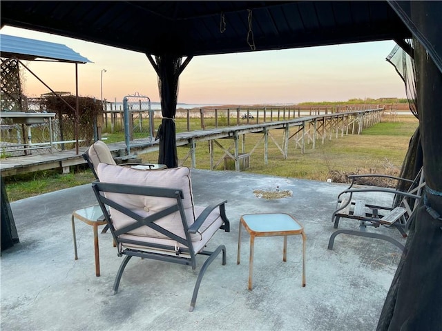 patio terrace at dusk featuring a gazebo