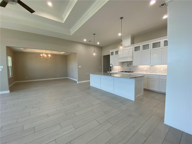 13941 Flintlock Dr, Corpus Christi, TX 78418 - kitchen featuring tasteful backsplash, a raised ceiling, open floor plan, recessed lighting, and a chandelier