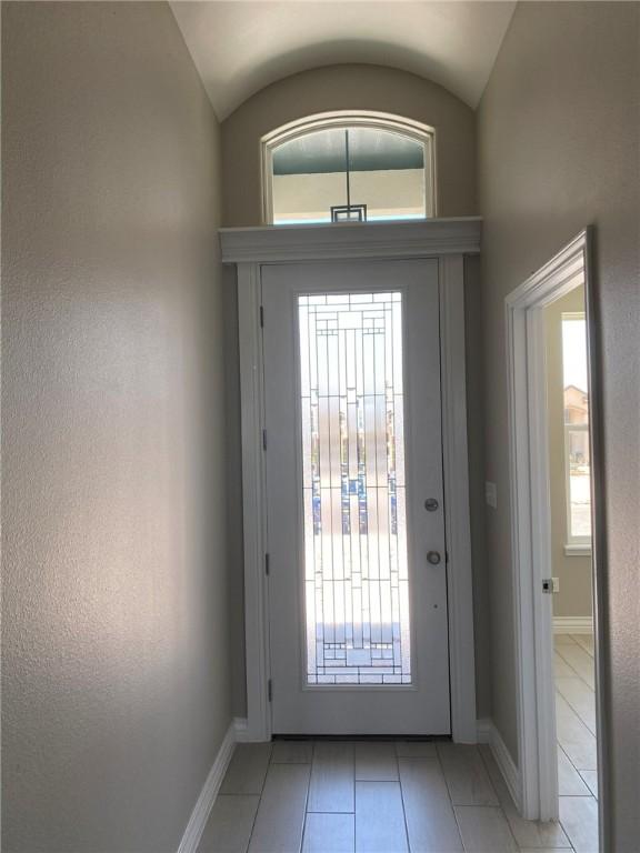 13941 Flintlock Dr, Corpus Christi, TX 78418 - foyer entrance featuring light tile patterned floors and vaulted ceiling